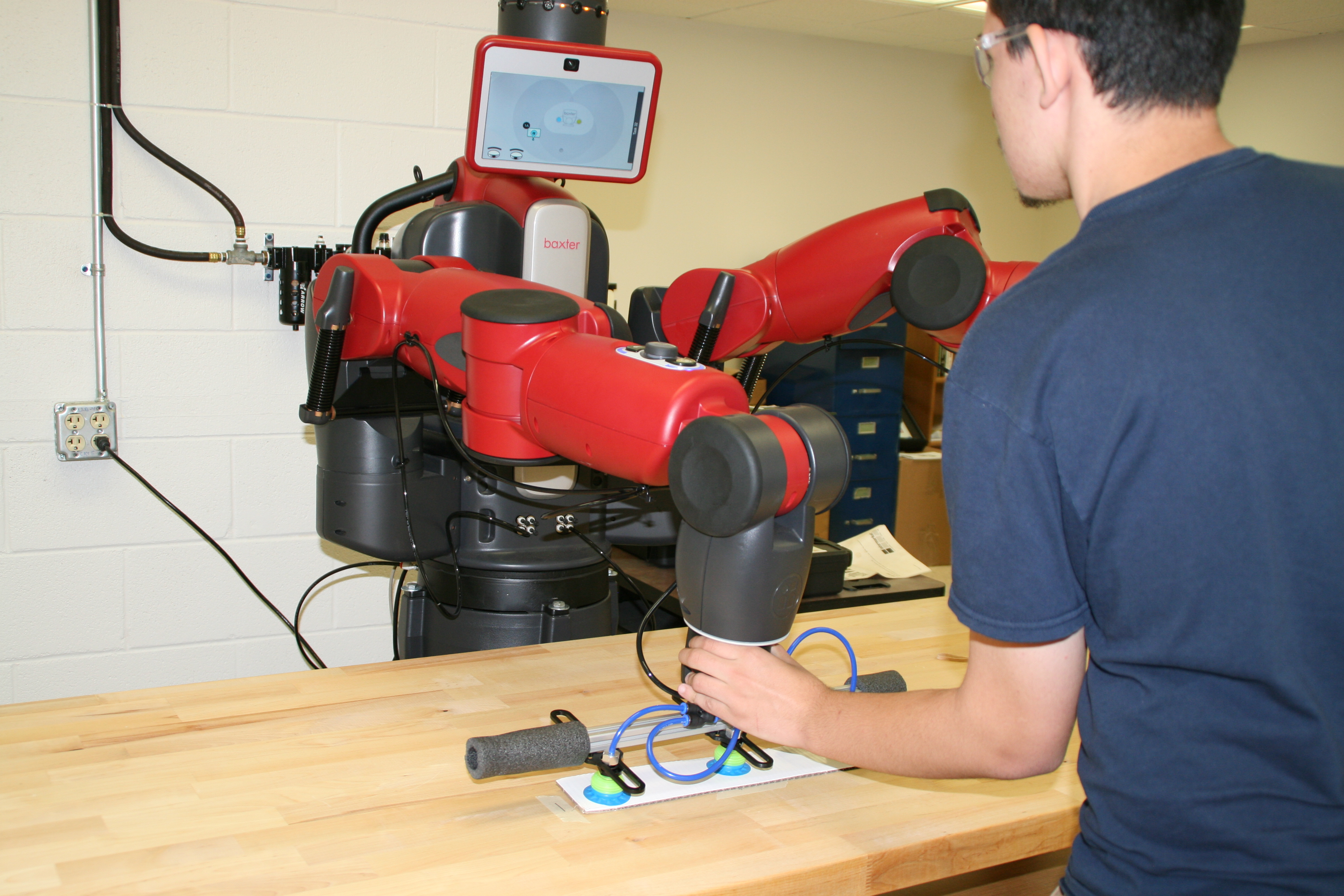 student workingn with robot 