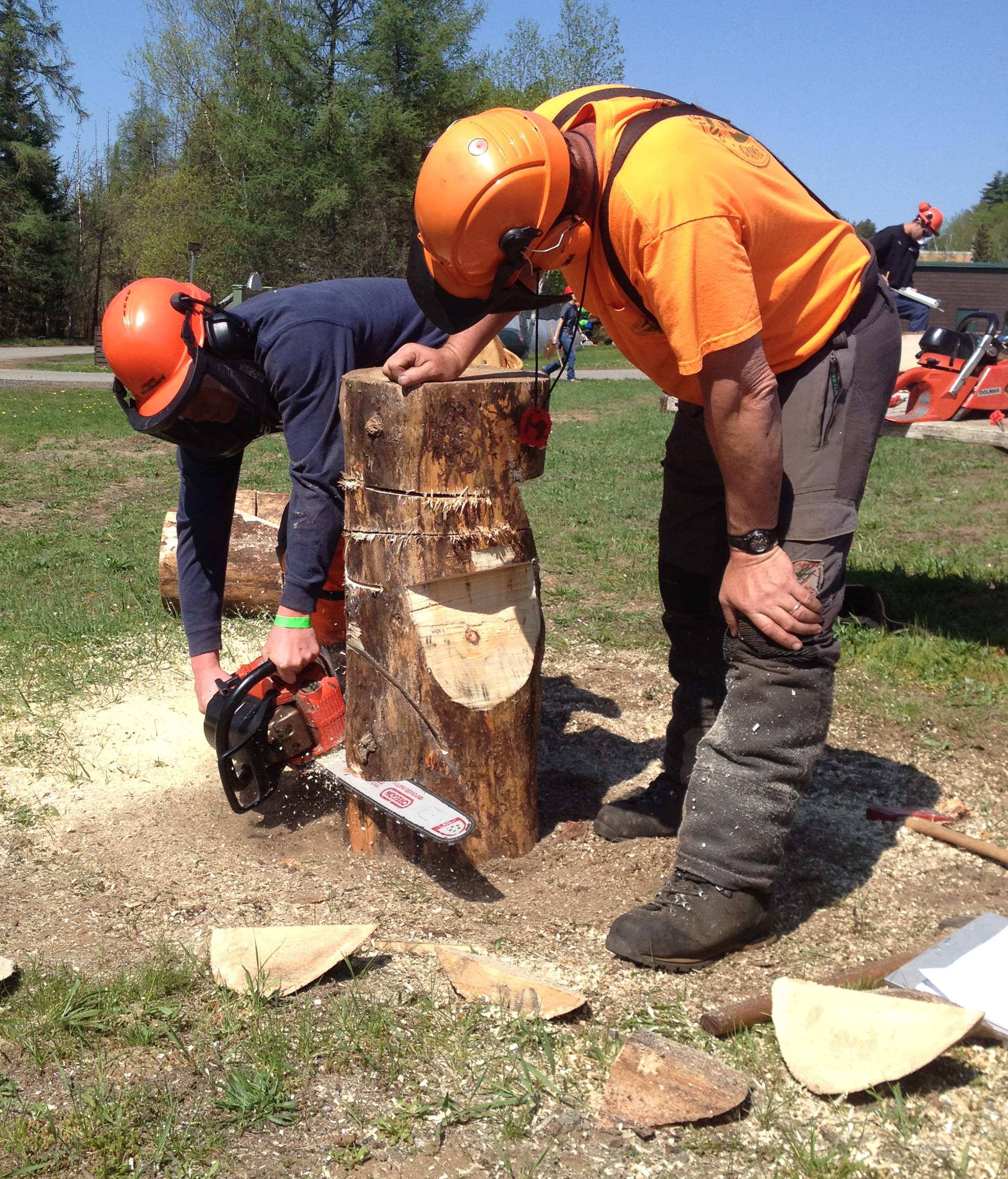 student works with chainsaw