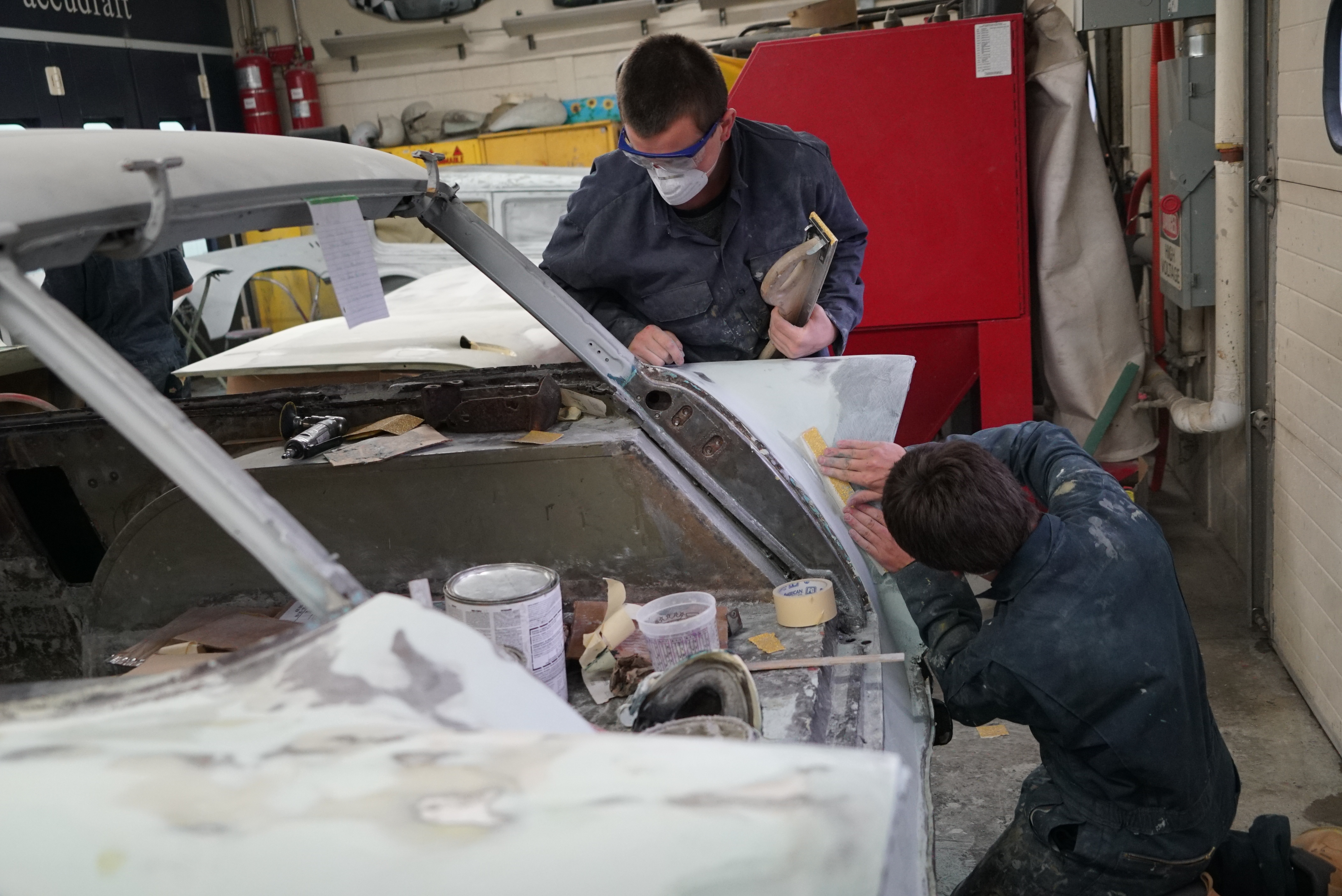 students work on car